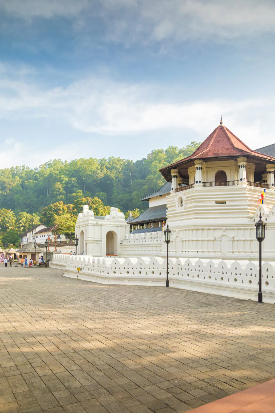 The octagon and white moat wall of the Temple of the Sacred Tooth Relic in morning light