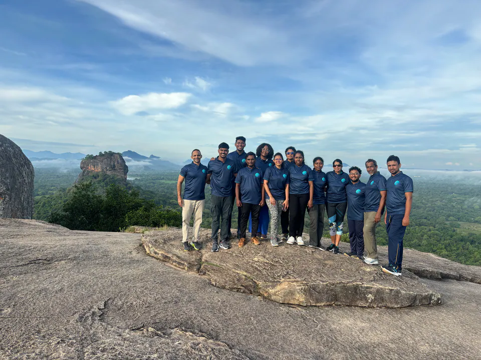 The Island Adventures team on Pidurangala rock, with Sigiriya and the forest behind