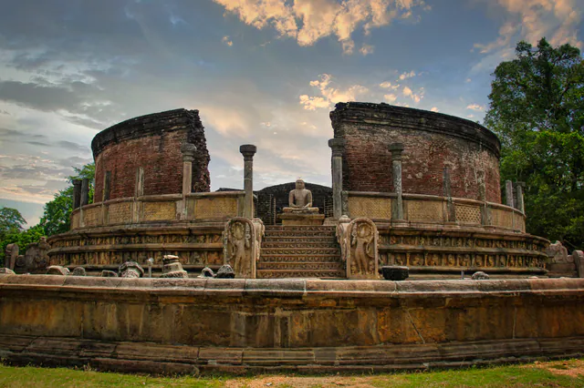 The Polonnaruwa Vatadage with its carved stairway and guardstones under an evening sky